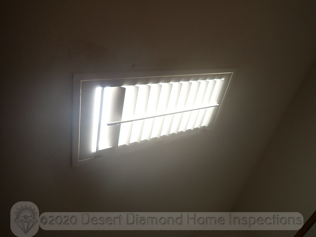 Plantation shutter mounted on ceiling at skylight