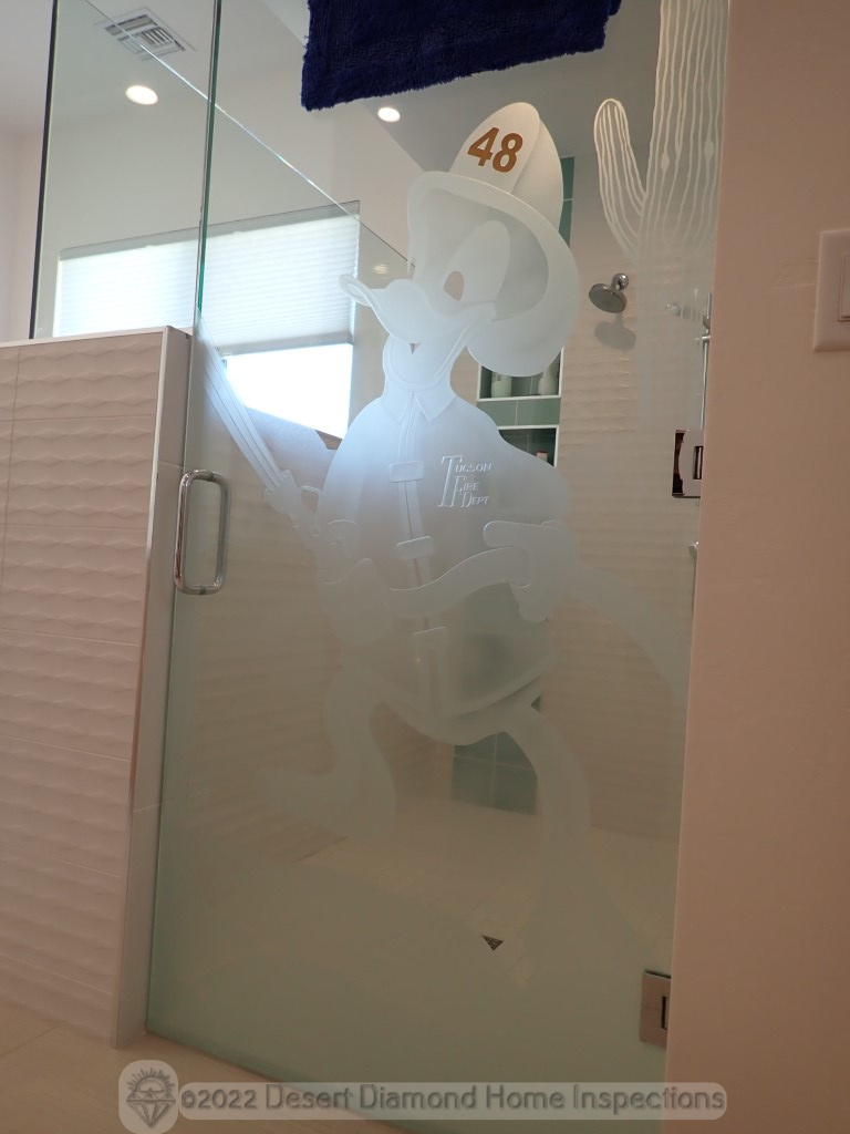 Custom etched shower door seen in a home of a retired firefighter