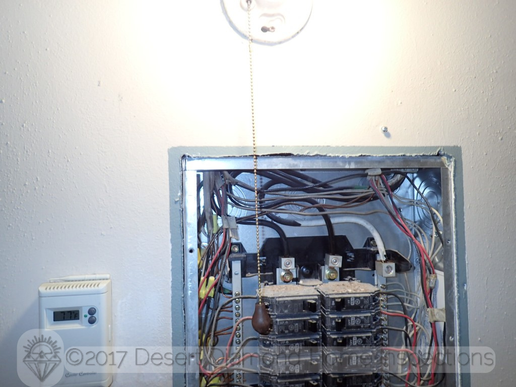 A light fixture with a metal pull chain directly  in front of the electrical sub-panel. What could possibly go wrong...