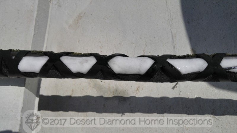 This photo was taken in July on a Tucson roof in direct sun light with an ambient temperature of well over 100 degrees. Yes, that is a thick layer of ice on the refrigerant lines of the AC.