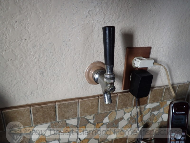 This convenient beer tap at the kitchen counter leads to the Kegerator in the garage on the other side of the well