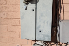 Bullet holes in an electrical main panel