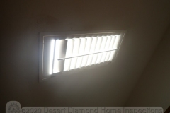 Plantation shutter mounted on ceiling at skylight