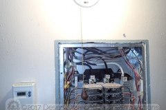 A light fixture with a metal pull chain directly  in front of the electrical sub-panel. What could possibly go wrong...