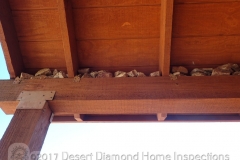 Rocks piled loosely on beam ten feet high over front entry
