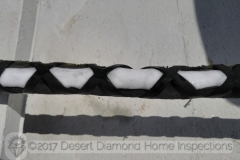 This photo was taken in July on a Tucson roof in direct sun light with an ambient temperature of well over 100 degrees. Yes, that is a thick layer of ice on the refrigerant lines of the AC.