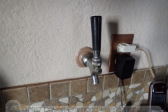 This convenient beer tap at the kitchen counter leads to the Kegerator in the garage on the other side of the well