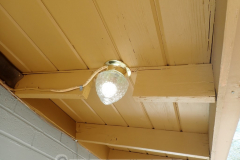 "This light absolutely must go here! No compromise. Rafter in the way? Don't care. Cut it out." - The light might be brighter than the person who installed it.