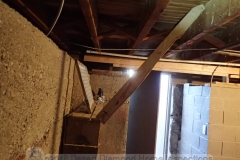 Apparently this is a load-bearing shelving unit helping to support the subflooring