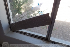 If you don't have a dowel handy to secure the window track, in a pinch a piece of tile will do just fine.