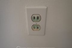 This outlet has been painted so many times, you can't even plug anything in anymore.