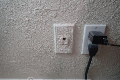 Textured right over the phone jack. Nobody is gonna use it anymore anyway, right?